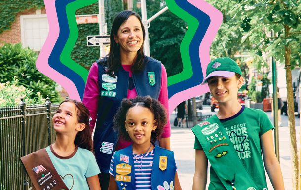 adult volunteer in vest with girl scouts